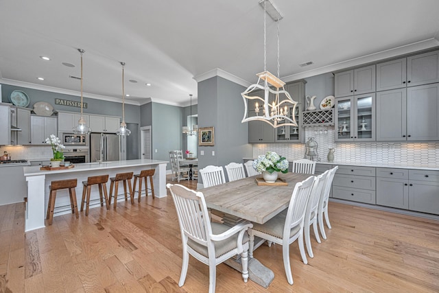 225 Camber Rd, Huger, SC 29450 - dining room with ornamental molding, recessed lighting, light wood-type flooring, and a chandelier