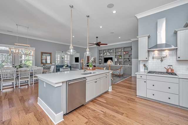 225 Camber Rd, Huger, SC 29450 - kitchen with appliances with stainless steel finishes, wall chimney exhaust hood, a ceiling fan, open floor plan, and ornamental molding