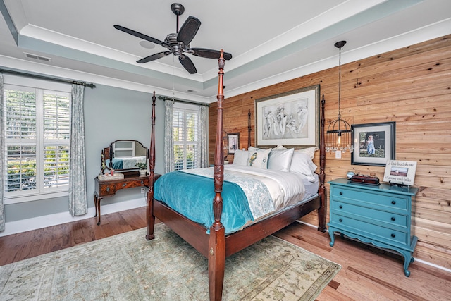 225 Camber Rd, Huger, SC 29450 - bedroom with wood walls, a raised ceiling, multiple windows, and wood finished floors