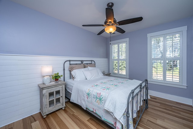 225 Camber Rd, Huger, SC 29450 - bedroom with wood finished floors, wainscoting, ceiling fan, and wood walls