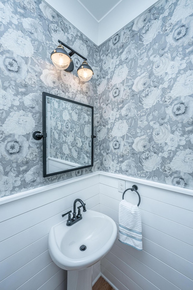225 Camber Rd, Huger, SC 29450 - bathroom featuring a wainscoted wall, a sink, wallpapered walls, and wood finished floors