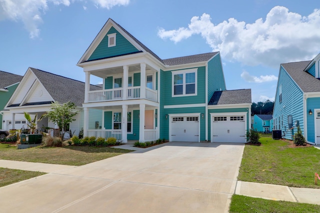 1238 Homecoming Blvd, Ravenel, SC 29470 - neoclassical home featuring a balcony, driveway, covered porch, roof with shingles, and a front lawn