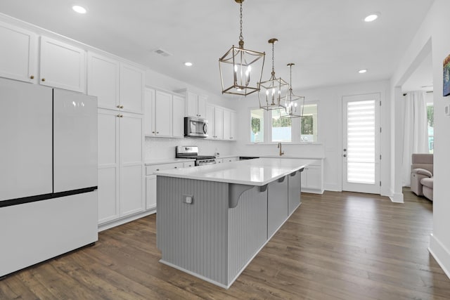 1238 Homecoming Blvd, Ravenel, SC 29470 - kitchen with white cabinets, an inviting chandelier, stainless steel appliances, and visible vents
