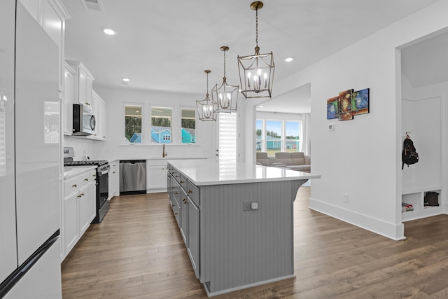 1238 Homecoming Blvd, Ravenel, SC 29470 - kitchen with a chandelier, stainless steel appliances, a healthy amount of sunlight, and white cabinets