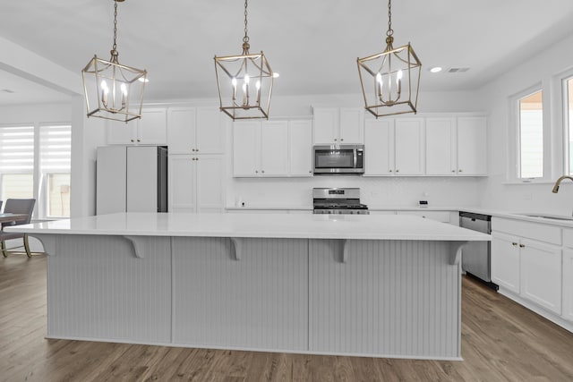 1238 Homecoming Blvd, Ravenel, SC 29470 - kitchen with a sink, a chandelier, light countertops, and appliances with stainless steel finishes