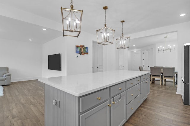 1238 Homecoming Blvd, Ravenel, SC 29470 - kitchen featuring open floor plan, an inviting chandelier, gray cabinetry, and wood finished floors