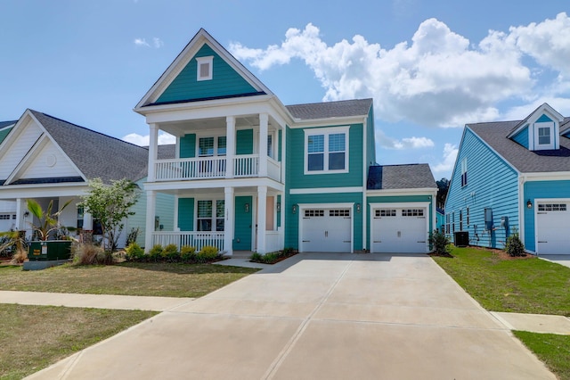 1238 Homecoming Blvd, Ravenel, SC 29470 - neoclassical home featuring a front lawn, concrete driveway, central air condition unit, a balcony, and a porch