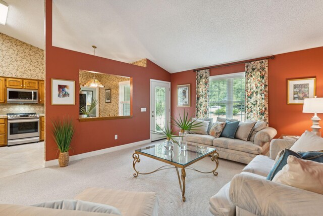 living room featuring vaulted ceiling, light carpet, and a textured ceiling