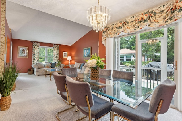 dining room featuring an inviting chandelier, vaulted ceiling, a textured ceiling, and carpet