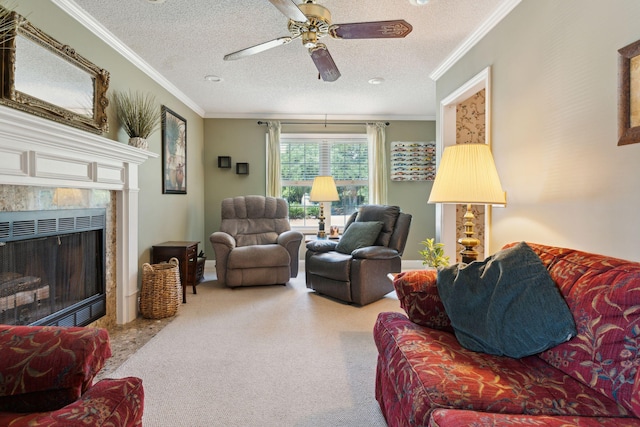 carpeted living room featuring ceiling fan, a fireplace, ornamental molding, and a textured ceiling