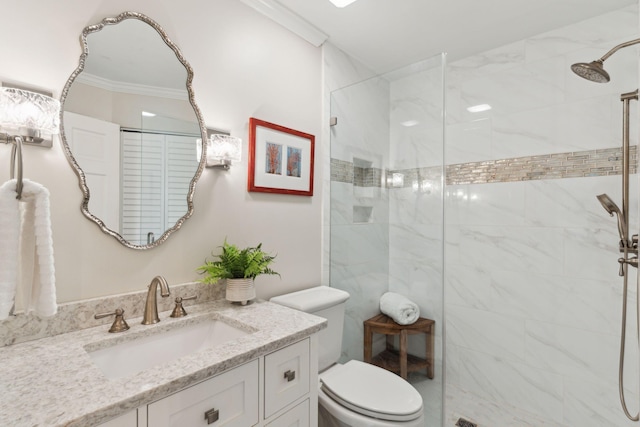 bathroom featuring crown molding, tiled shower, vanity, and toilet