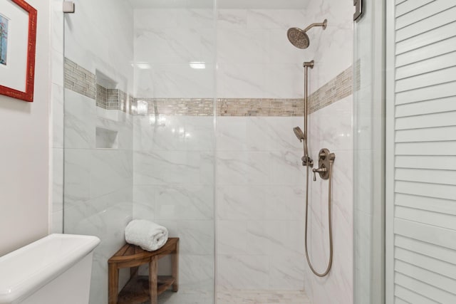 bathroom with tiled shower and toilet