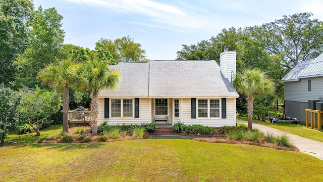 view of front of property featuring a front yard and central air condition unit