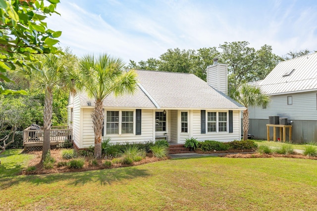 view of front of house featuring a wooden deck, central air condition unit, and a front lawn