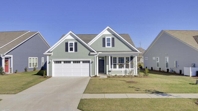 view of front of home featuring a porch, a garage, and a front yard