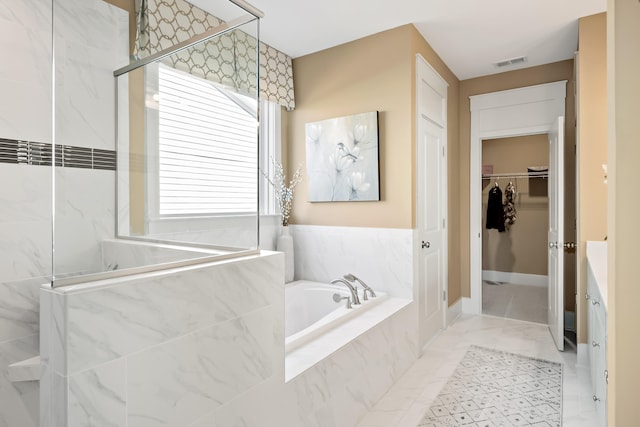 bathroom with independent shower and bath and tile patterned floors