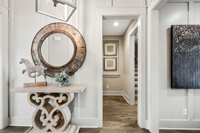 hallway with dark tile patterned flooring