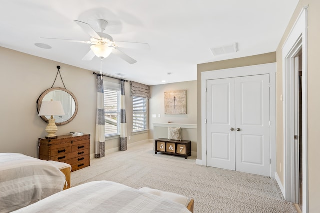 bedroom with light carpet, a closet, and ceiling fan