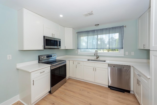 4836 Hillock Ave, North Charleston, SC 29418 - kitchen with stainless steel appliances, white cabinets, light wood finished floors, light countertops, and recessed lighting