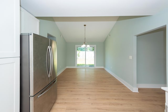4836 Hillock Ave, North Charleston, SC 29418 - kitchen with freestanding refrigerator, light wood-style flooring, white cabinets, vaulted ceiling, and hanging light fixtures