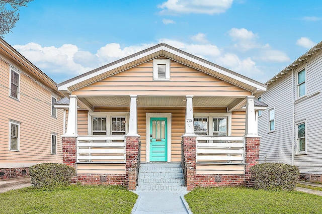 view of front of house featuring a porch and brick siding