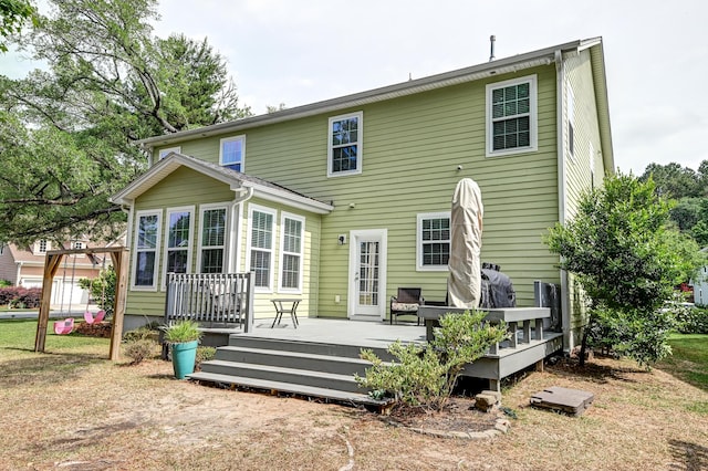 back of property with a wooden deck