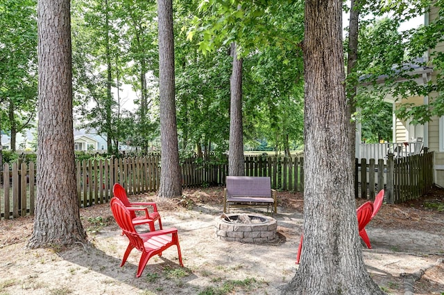 view of yard with a fire pit and fence