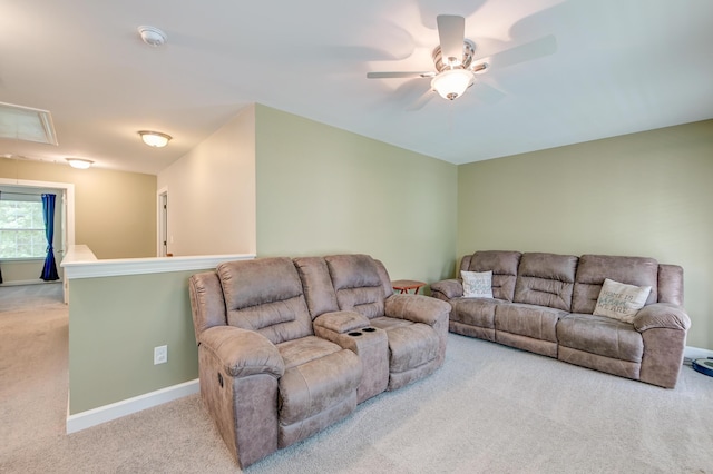 living room featuring carpet, ceiling fan, attic access, and baseboards