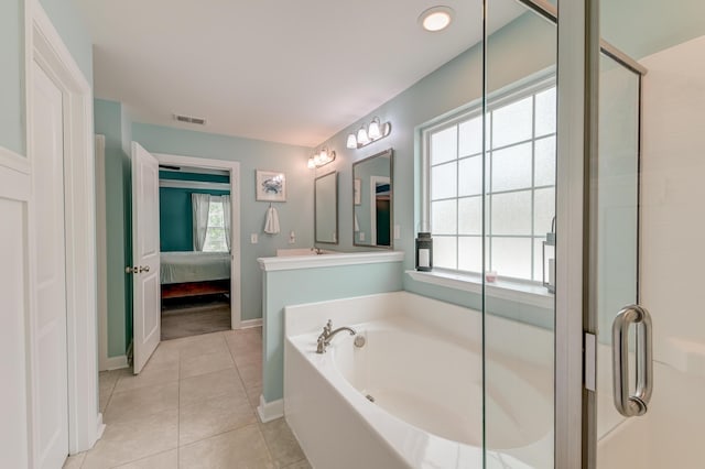 ensuite bathroom featuring plenty of natural light, a garden tub, tile patterned flooring, and a shower with shower door
