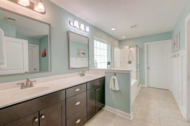 bathroom with a shower with door, tile patterned floors, double vanity, a bath, and recessed lighting