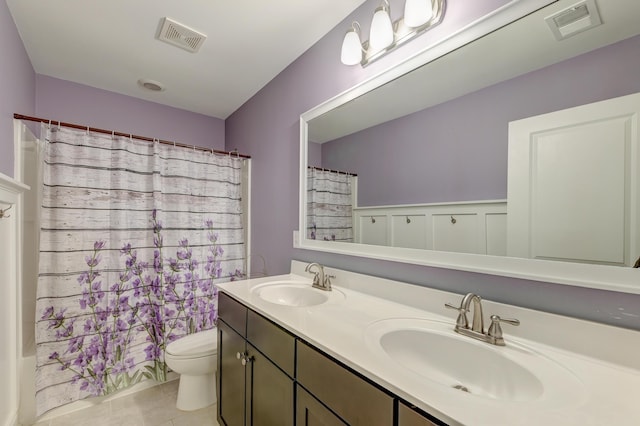 full bathroom featuring tile patterned floors, toilet, double vanity, and shower / bathtub combination with curtain