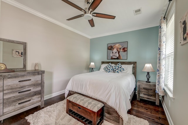bedroom featuring ornamental molding, dark wood-style flooring, baseboards, and a ceiling fan