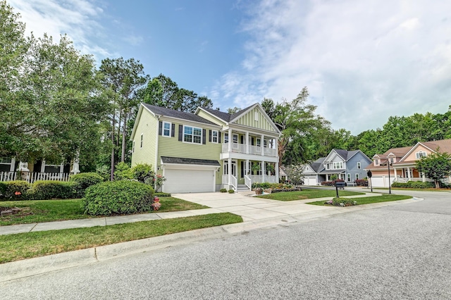 view of front of home featuring driveway, a balcony, an attached garage, board and batten siding, and covered porch