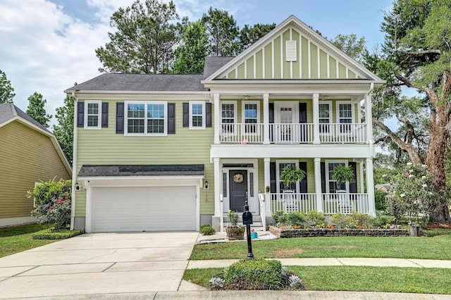 view of front of property featuring a porch, a balcony, driveway, a garage, and a front yard