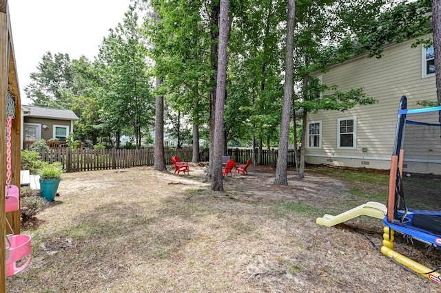 fenced yard with a trampoline