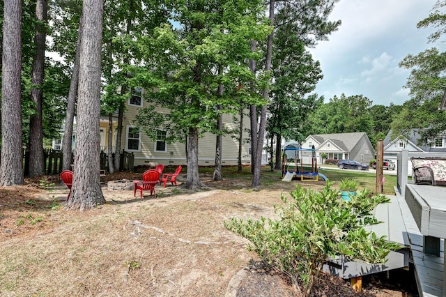 view of yard featuring an outdoor fire pit and a playground