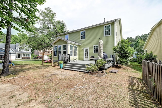rear view of property featuring a deck
