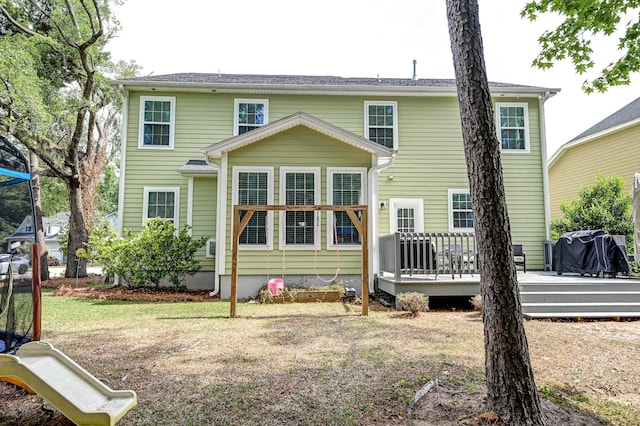 rear view of house featuring a wooden deck