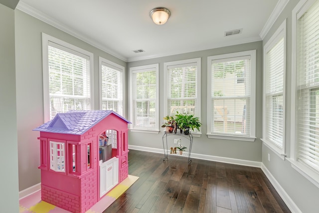 game room with hardwood / wood-style floors, crown molding, and baseboards