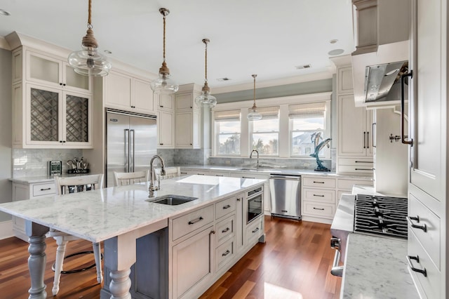 4001 Palm Blvd, Isle Of Palms, SC 29451 - kitchen featuring stainless steel appliances, a sink, decorative backsplash, a breakfast bar, and crown molding