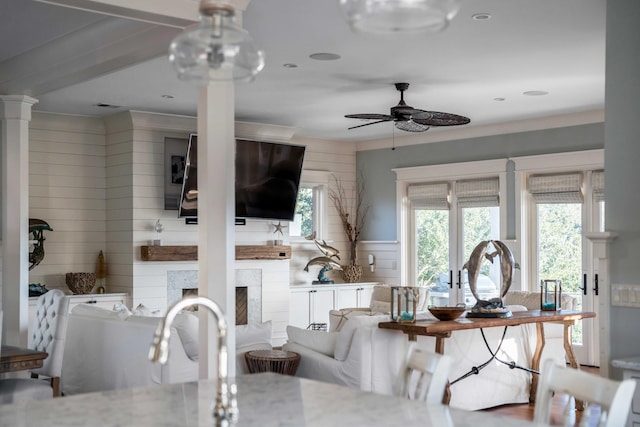 4001 Palm Blvd, Isle Of Palms, SC 29451 - living area featuring a ceiling fan, decorative columns, a fireplace, and healthy amount of natural light
