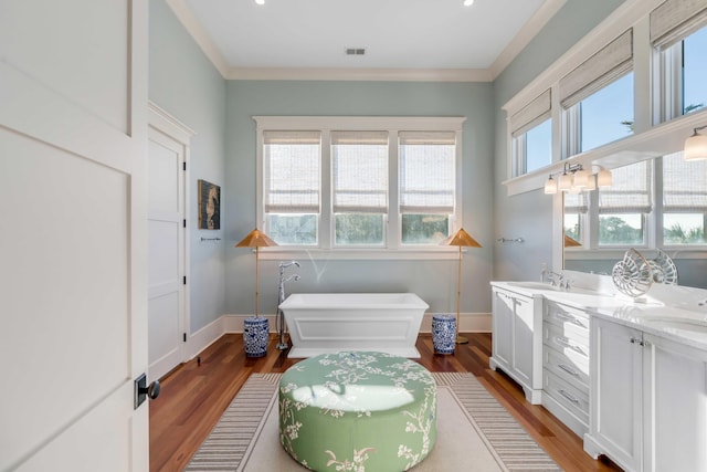 4001 Palm Blvd, Isle Of Palms, SC 29451 - full bath featuring a soaking tub, wood finished floors, double vanity, baseboards, and ornamental molding