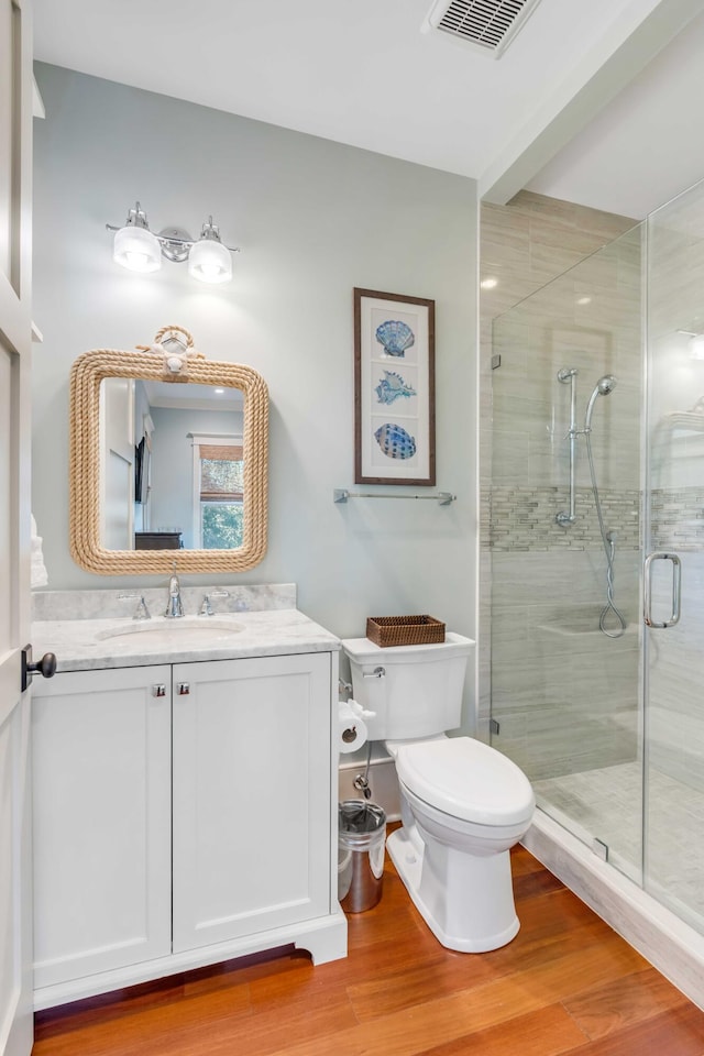 4001 Palm Blvd, Isle Of Palms, SC 29451 - bathroom featuring toilet, vanity, a stall shower, and wood finished floors