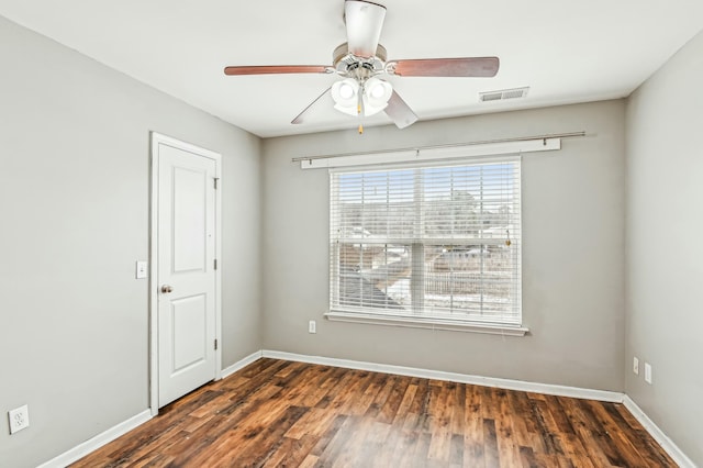 empty room with dark hardwood / wood-style floors and ceiling fan