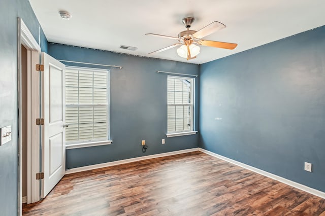 unfurnished room featuring ceiling fan and hardwood / wood-style floors