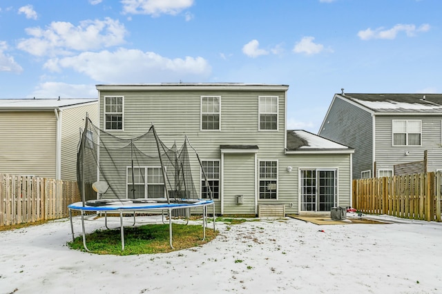 rear view of property featuring a trampoline