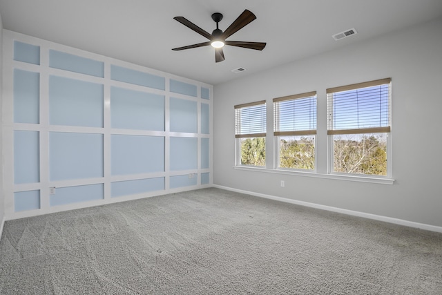 carpeted empty room featuring ceiling fan