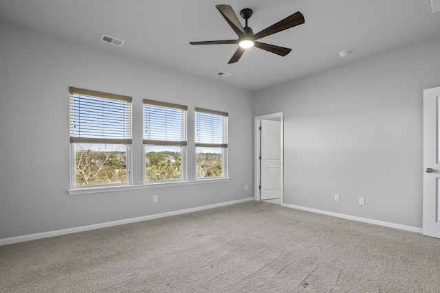 unfurnished room with ceiling fan and carpet floors