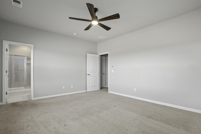 unfurnished bedroom with ceiling fan, ensuite bath, and carpet flooring