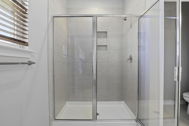 bathroom with toilet and walk in shower